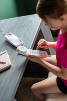 Girl dialing at desk