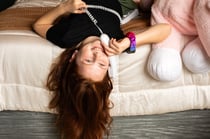 Girl hanging off bed Pinwheel Home